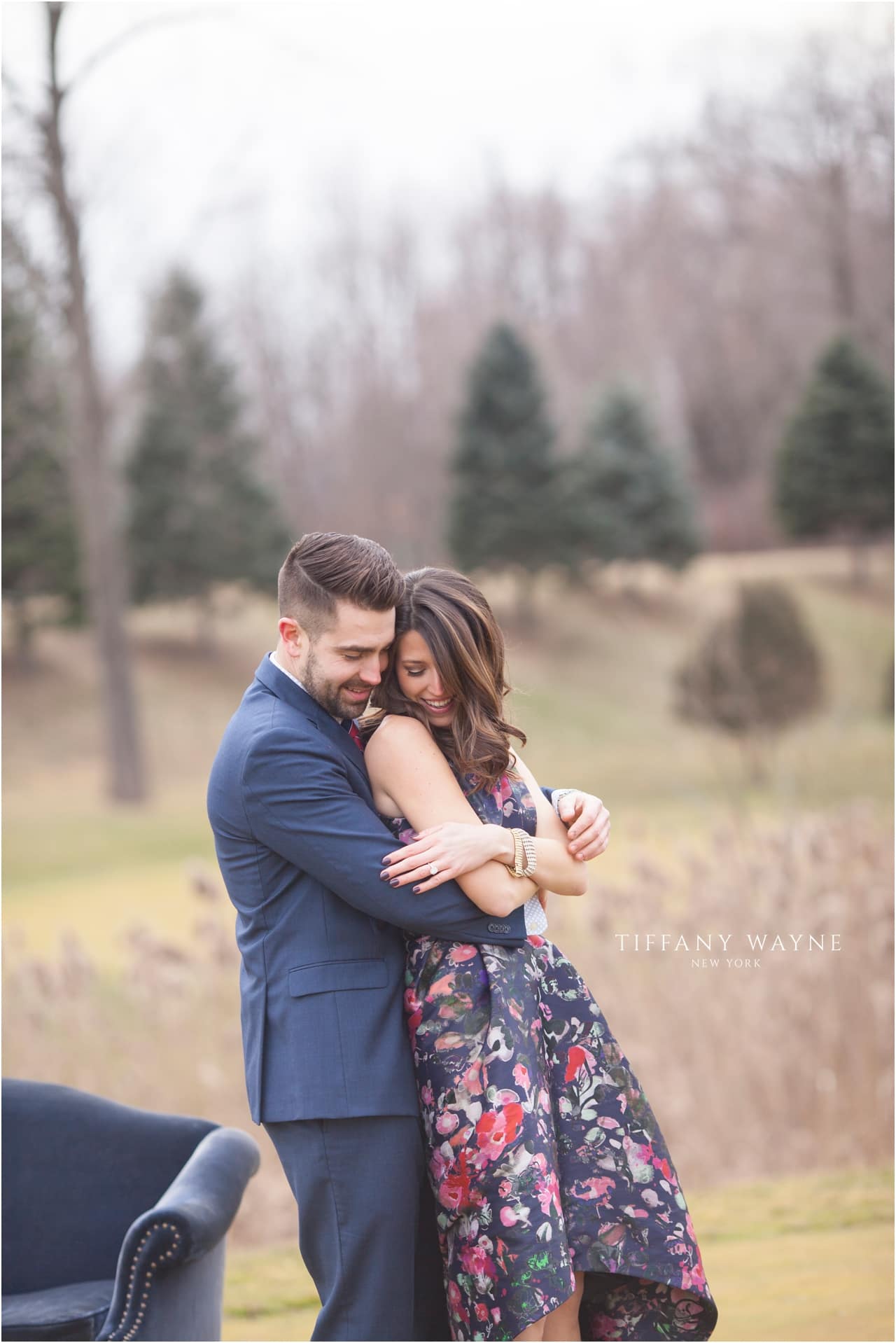 couple cozies up during engagement session featuring vintage sofa
