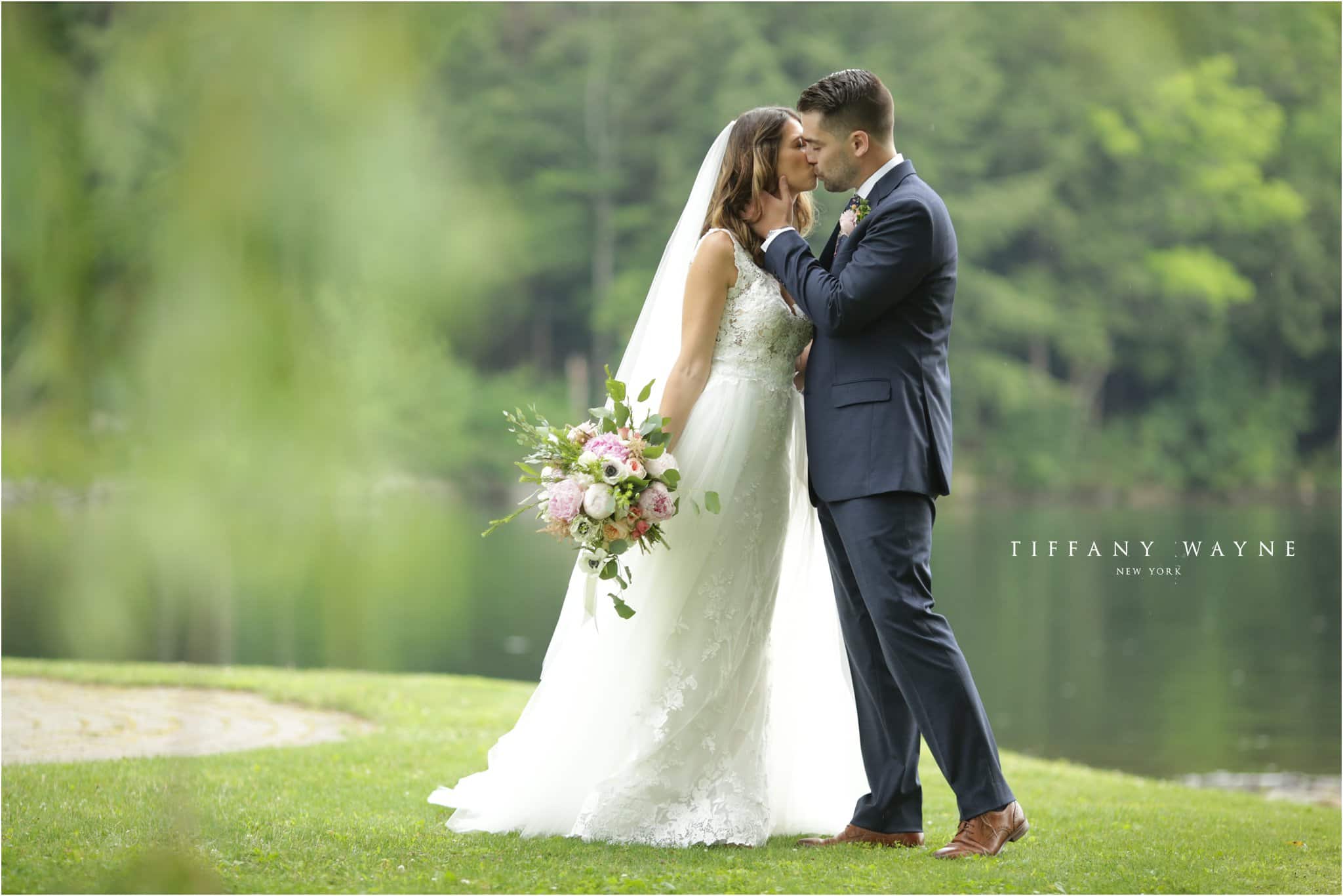 Crooked Lake House wedding portrait groom kissing bride