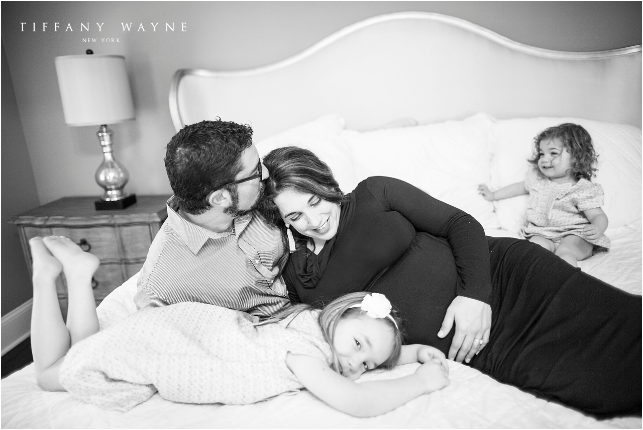 Lifestyle maternity session father kissing mother's head