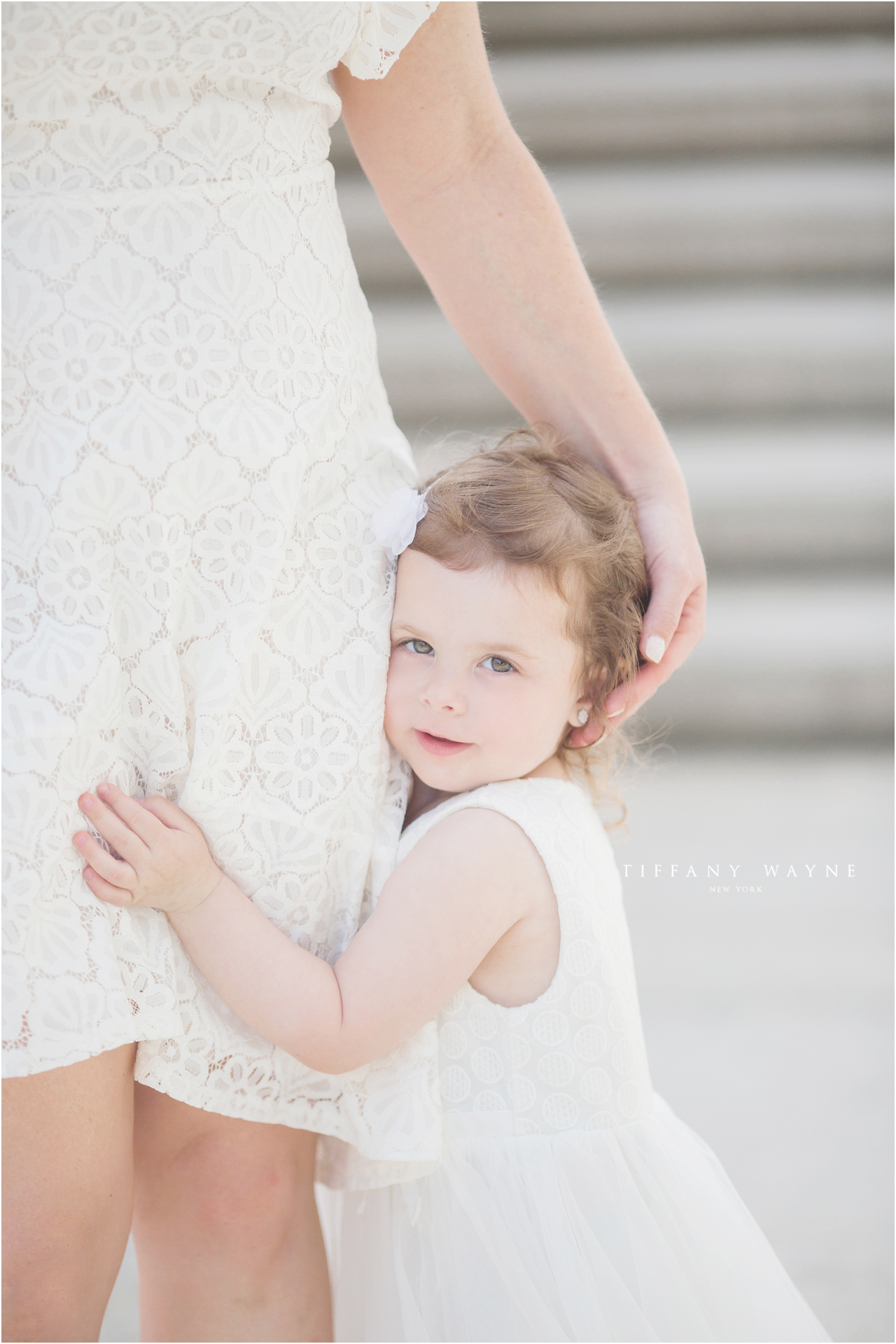 little girl hugs mom during mommy and me lifestyle session