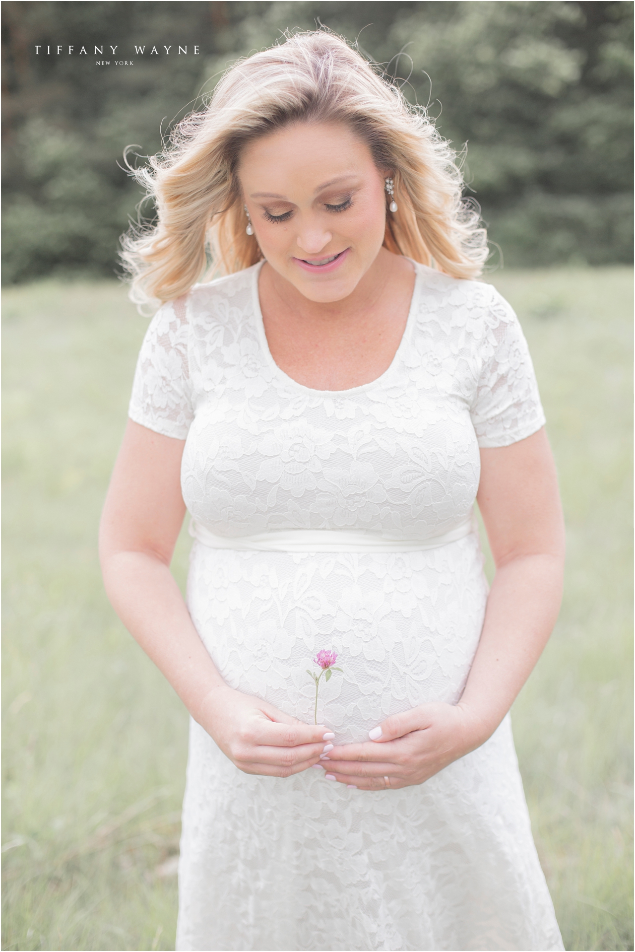 outdoor maternity session albany NY maternity photographer mom with flower and baby bump