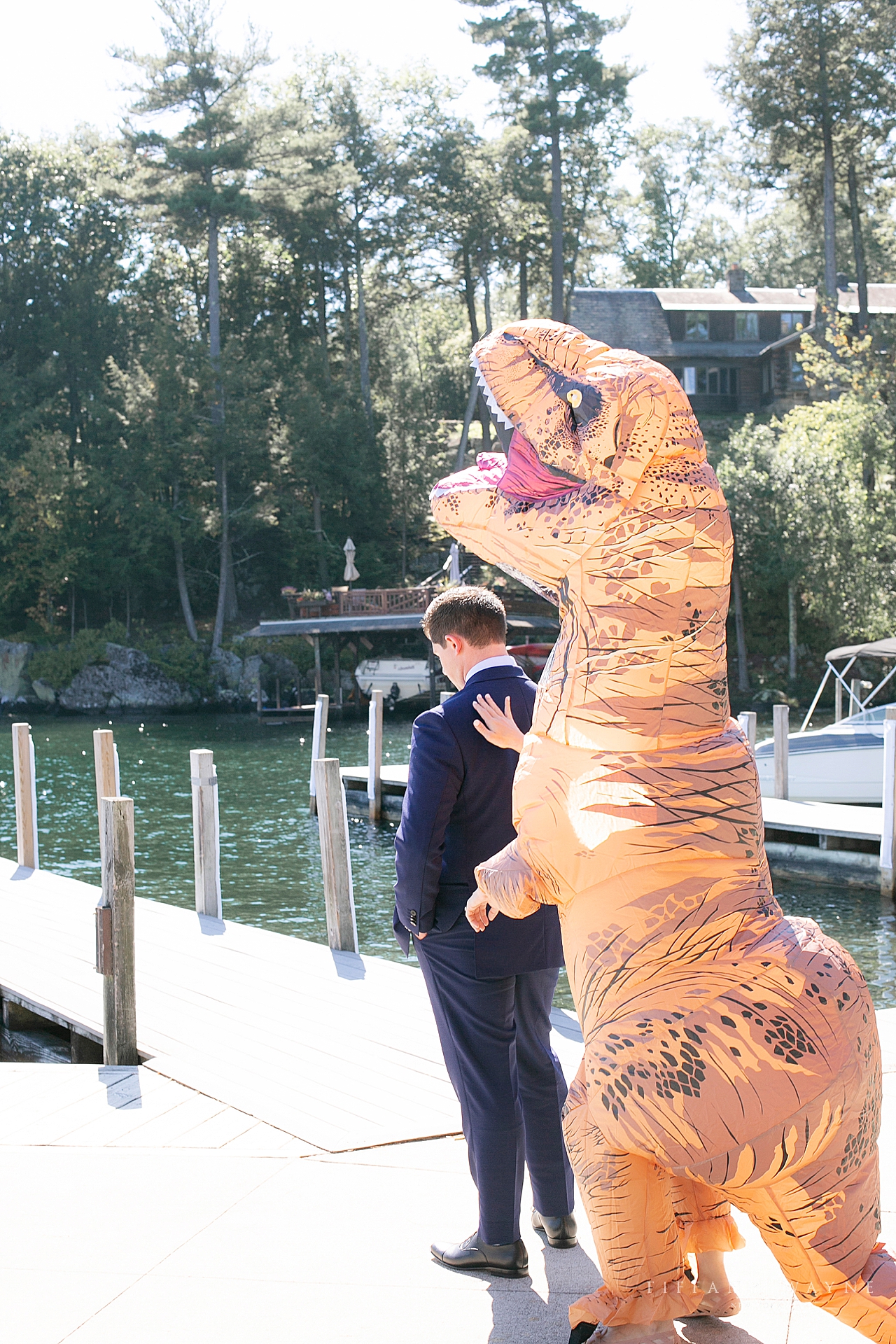 funny first look with T-Rex suit photographed by wedding photographer Tiffany Wayne 