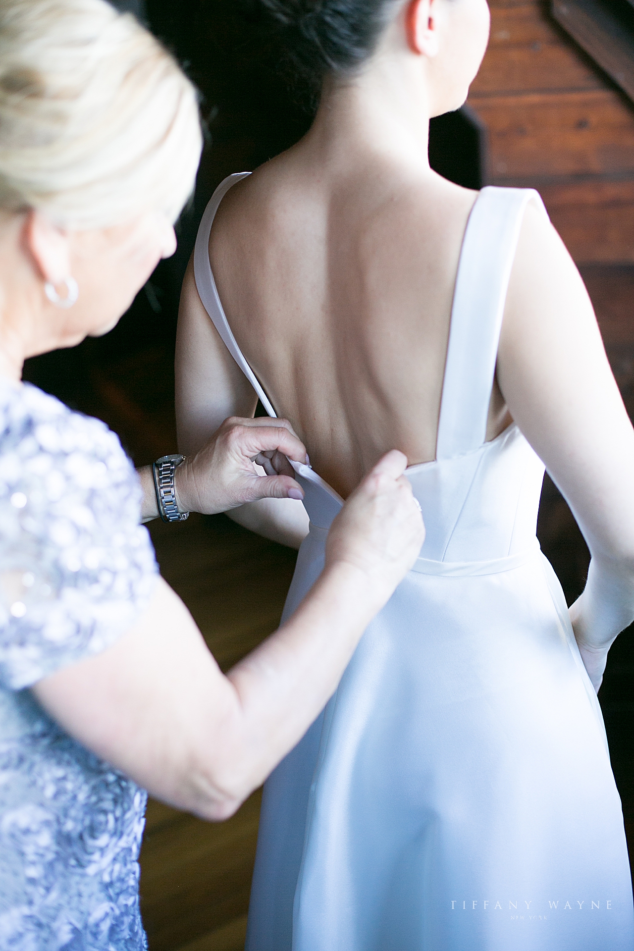 mom zips up daughter's gown at Lake George Club photographed by wedding photographer Tiffany Wayne