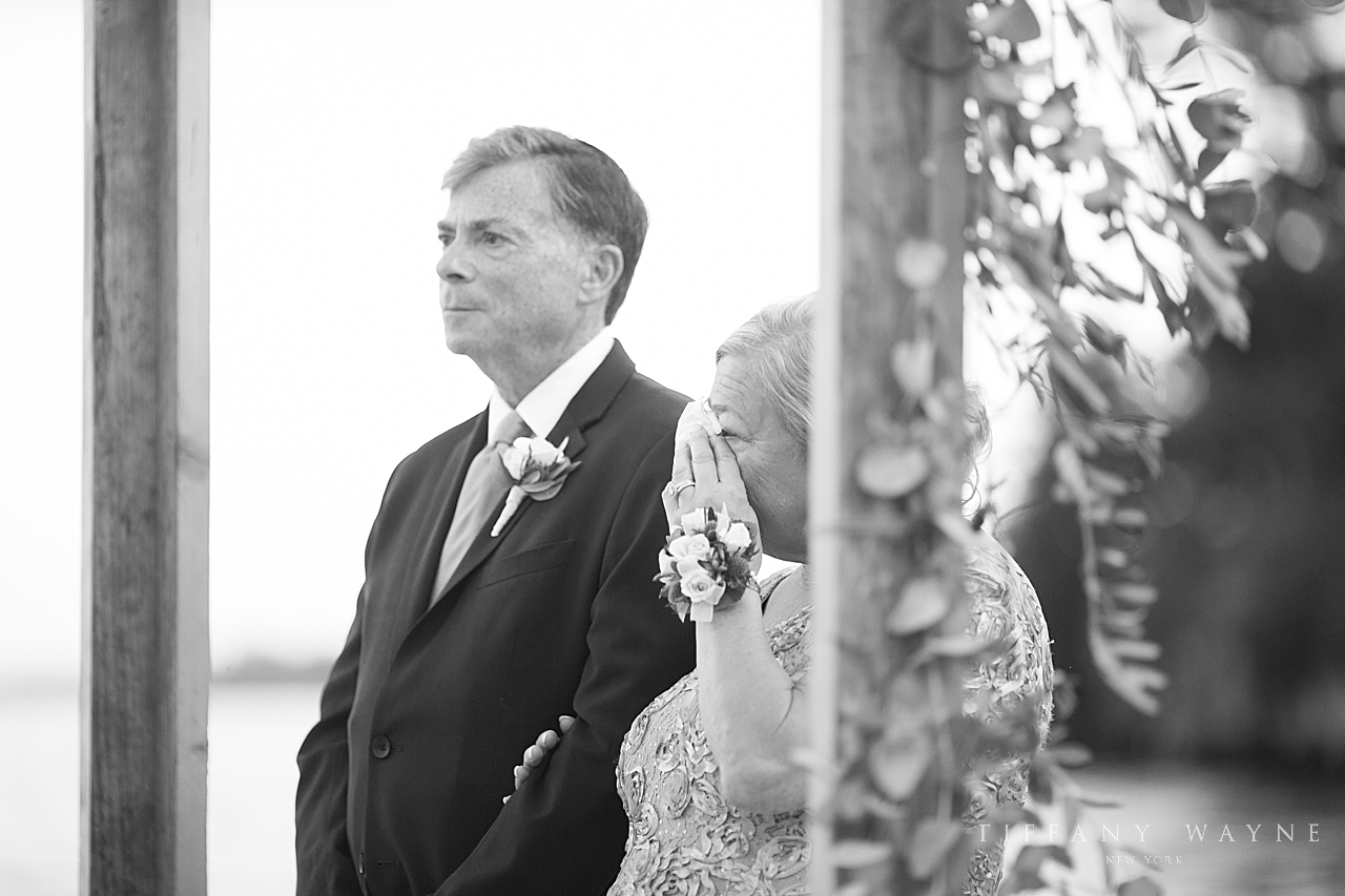 father of bride watches ceremony at Lake George Club by wedding photographer Tiffany Wayne
