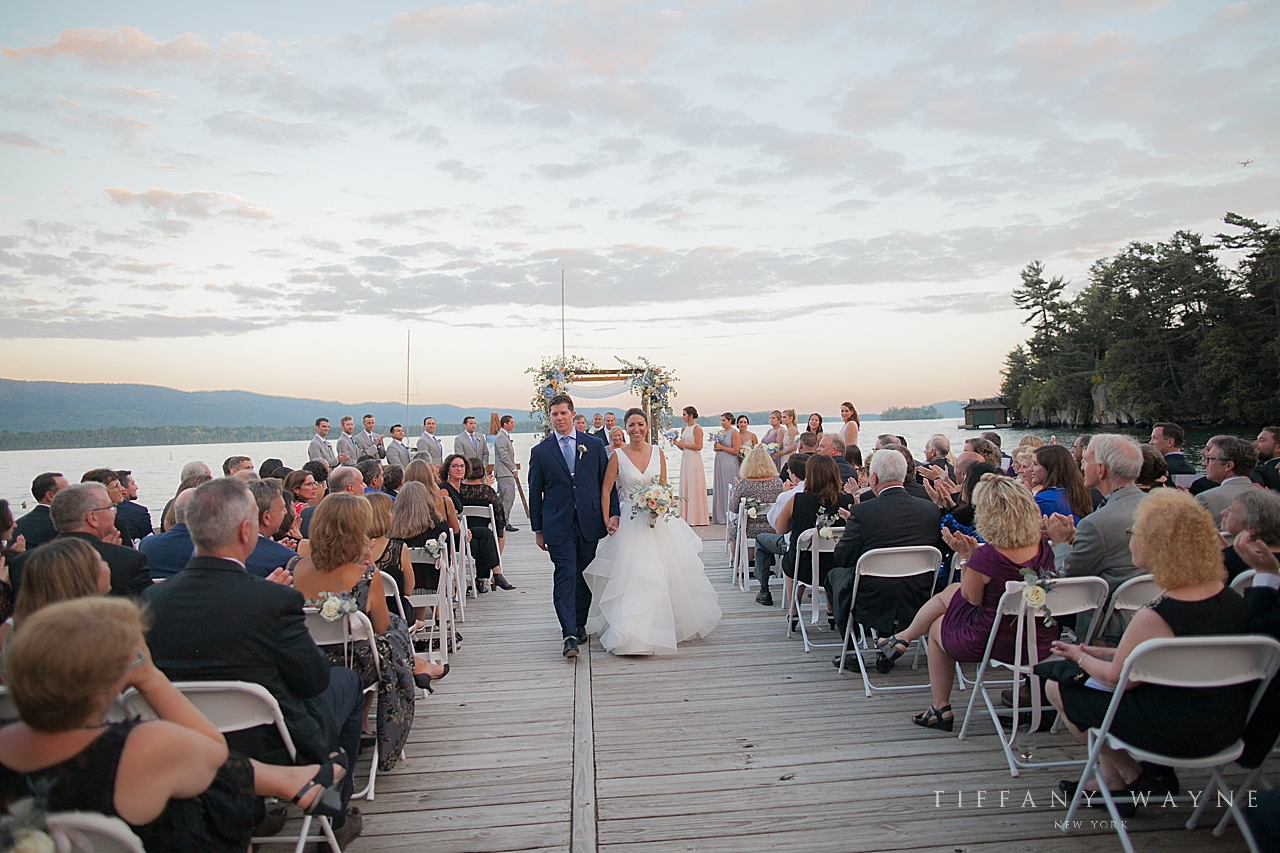 bride and groom recess up aisle at Lake George Club photographed by wedding photographer Tiffany Wayne