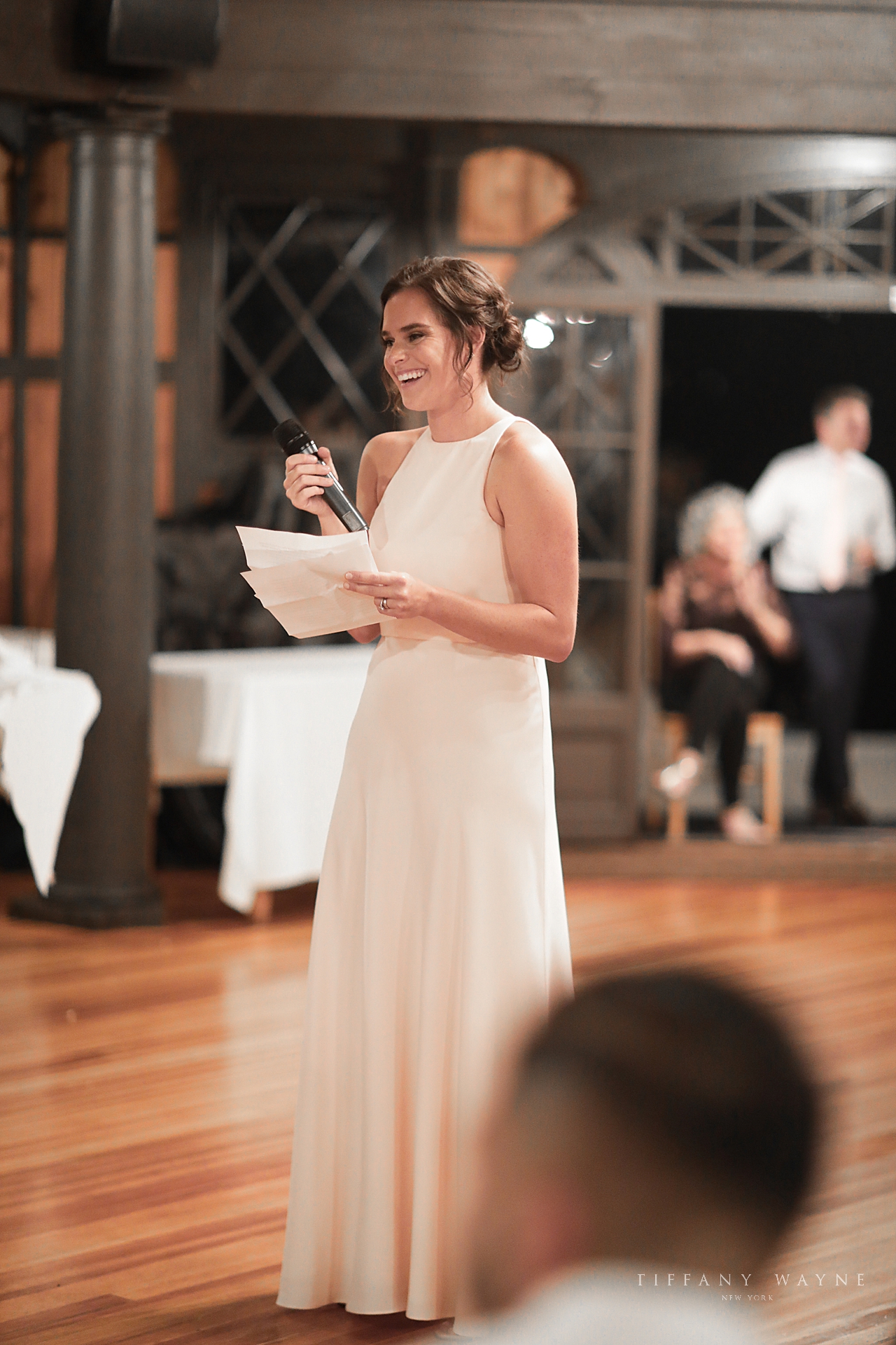 bridesmaid gives toast photographed by wedding photographer Tiffany Wayne