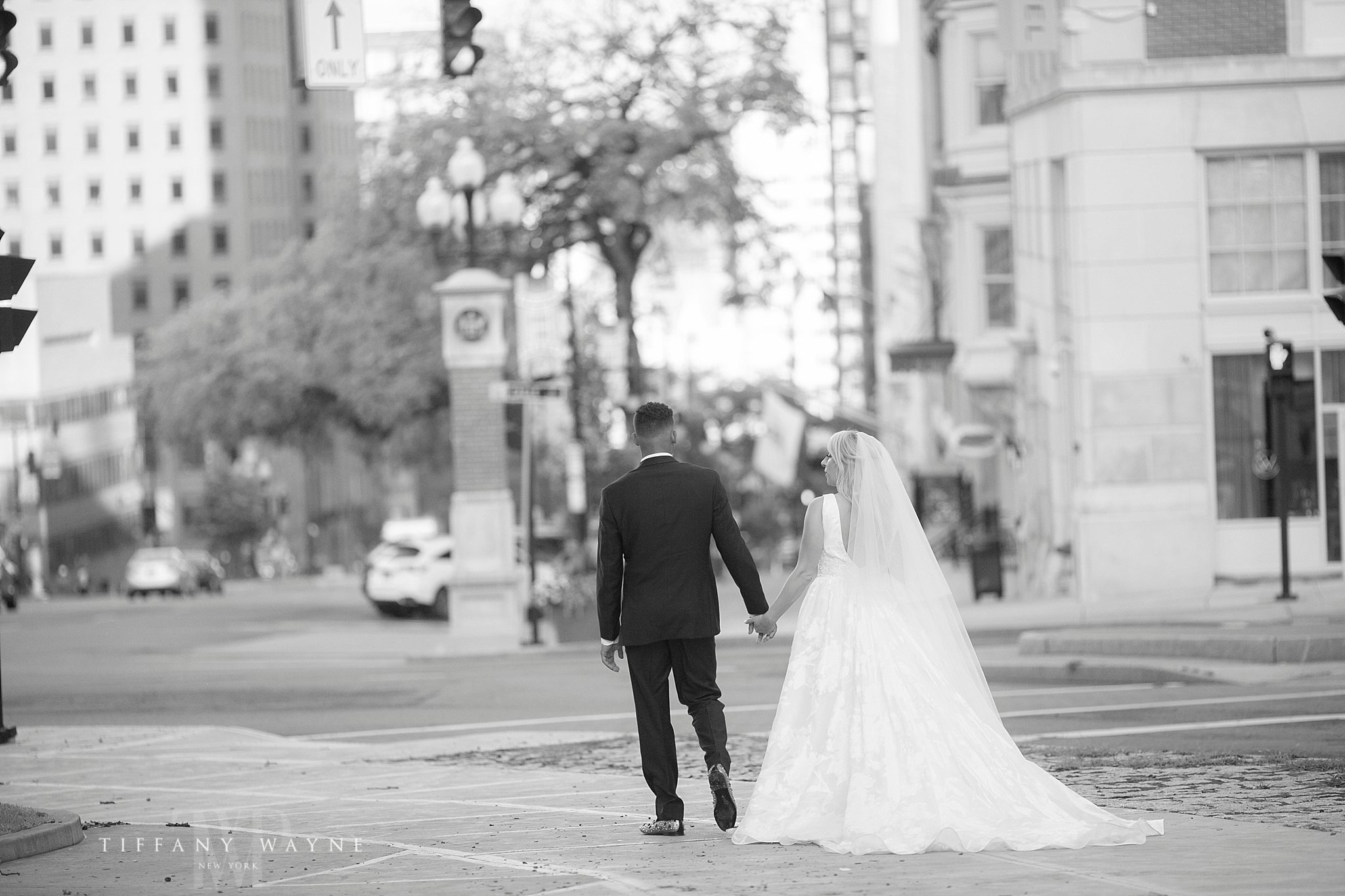 bride and groom walk on wedding day photographed by Tiffany Wayne Photography