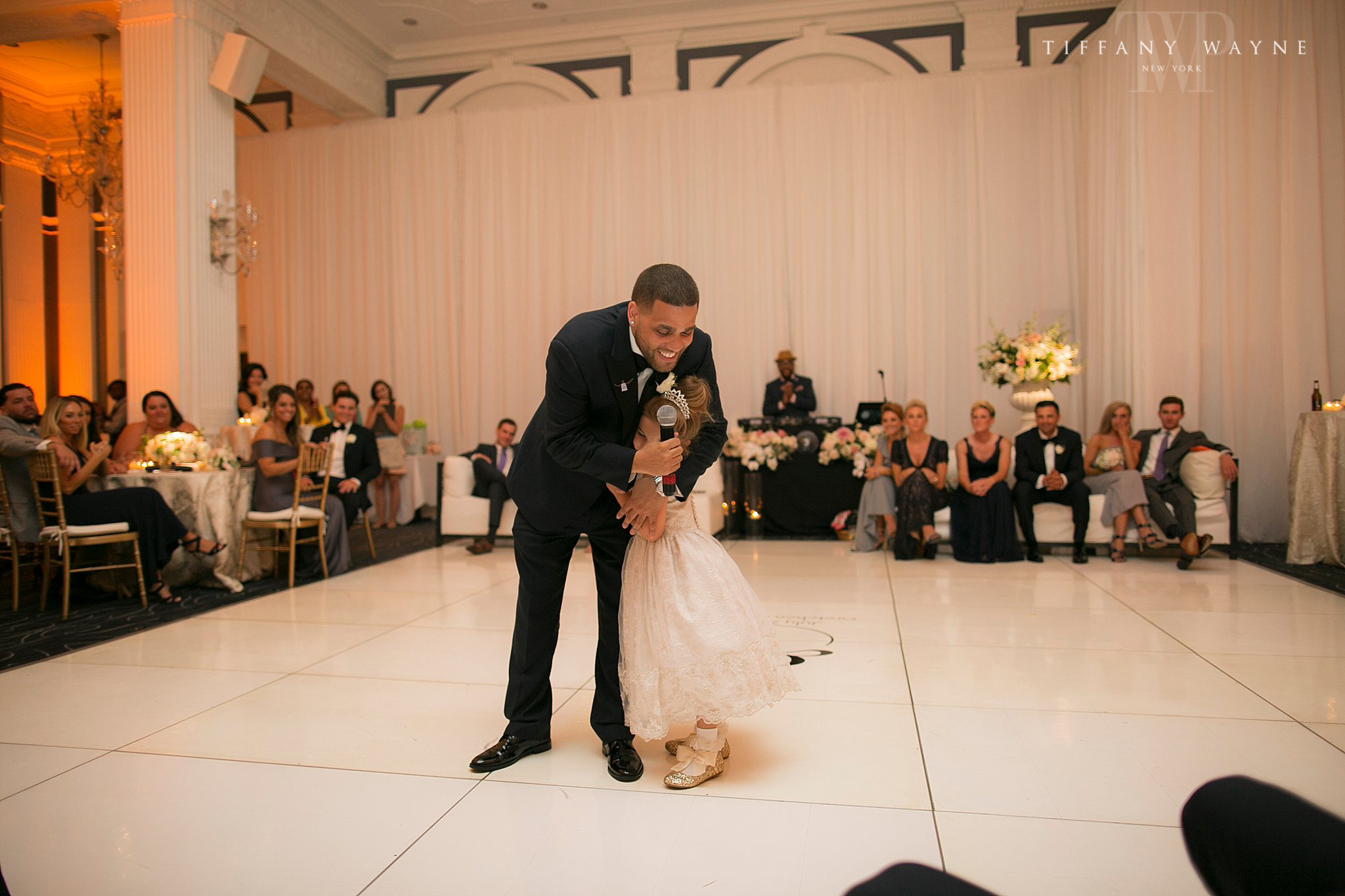 groom and flower girl at wedding reception photographed by Tiffany Wayne Photography