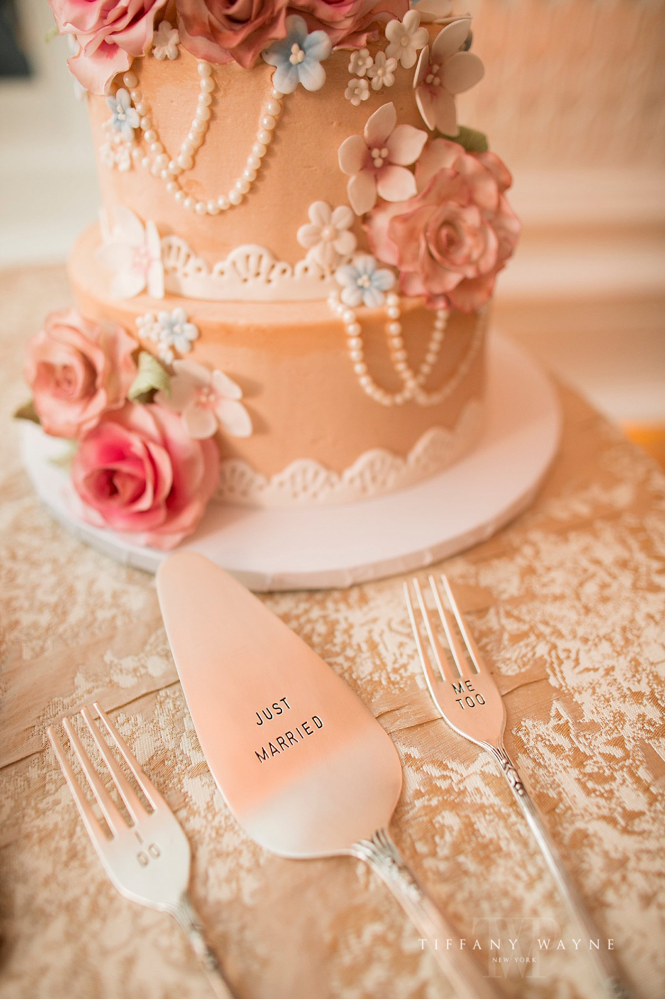Blush and peach tiered wedding cake photographed by Tiffany Wayne Photography
