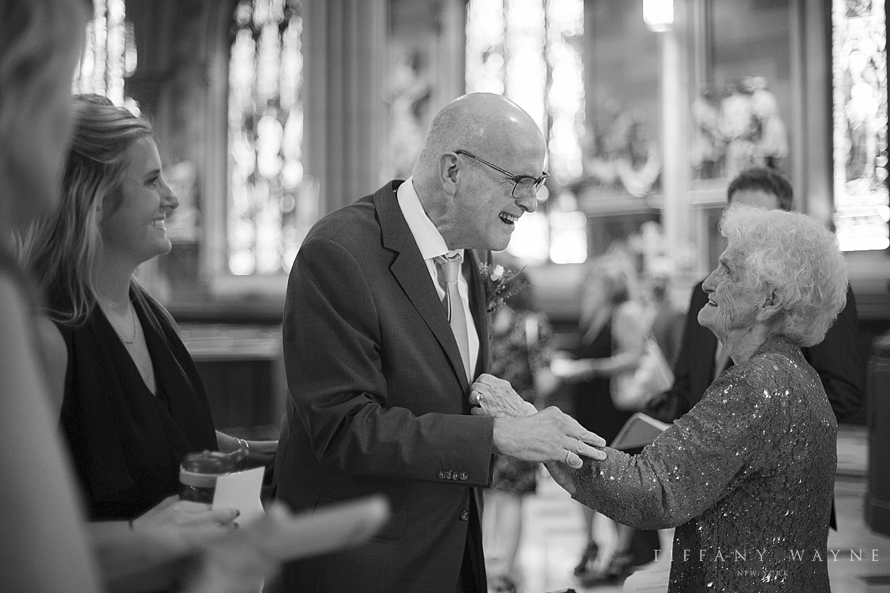father of bride greets guests photographed by wedding photographer Tiffany Wayne