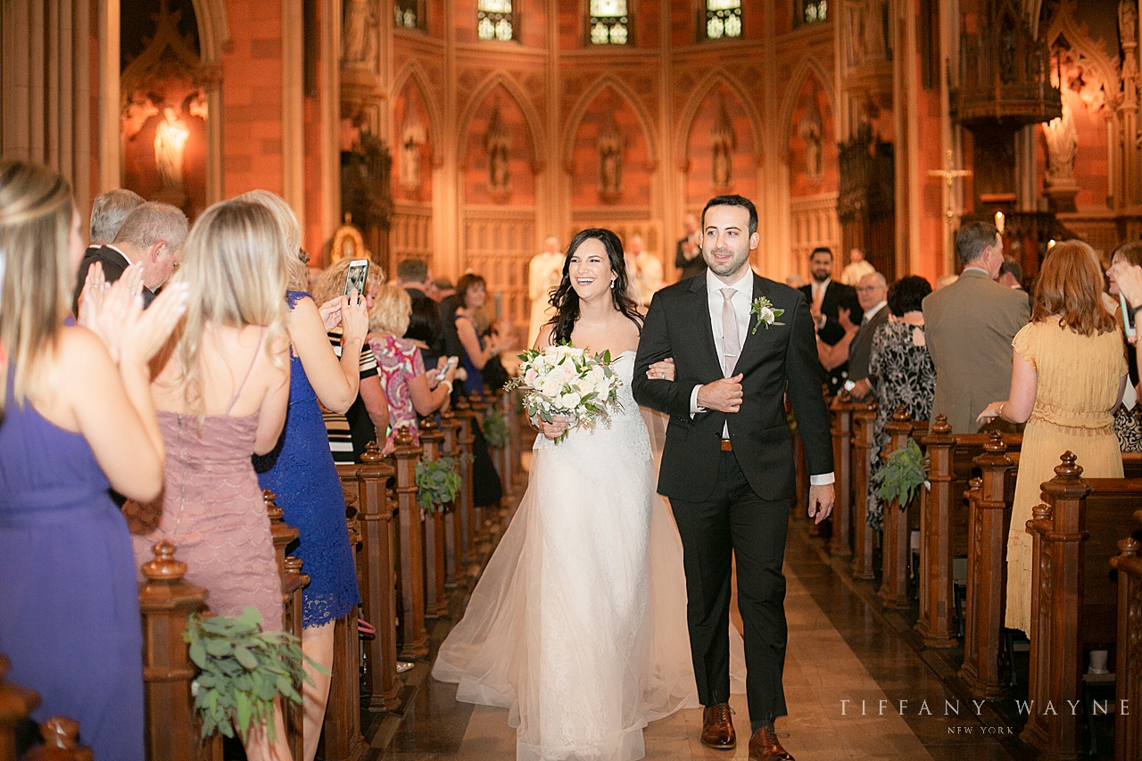 bride and groom recess in church photographed by wedding photographer Tiffany Wayne