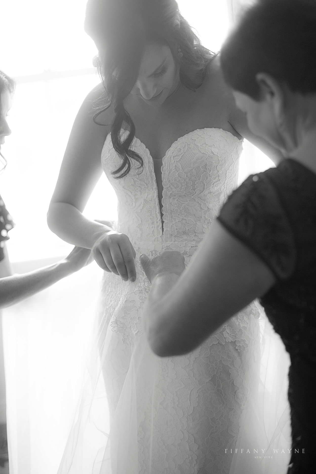bridesmaids attach skirt of wedding dress for bride photographed by New York wedding photographer Tiffany Wayne