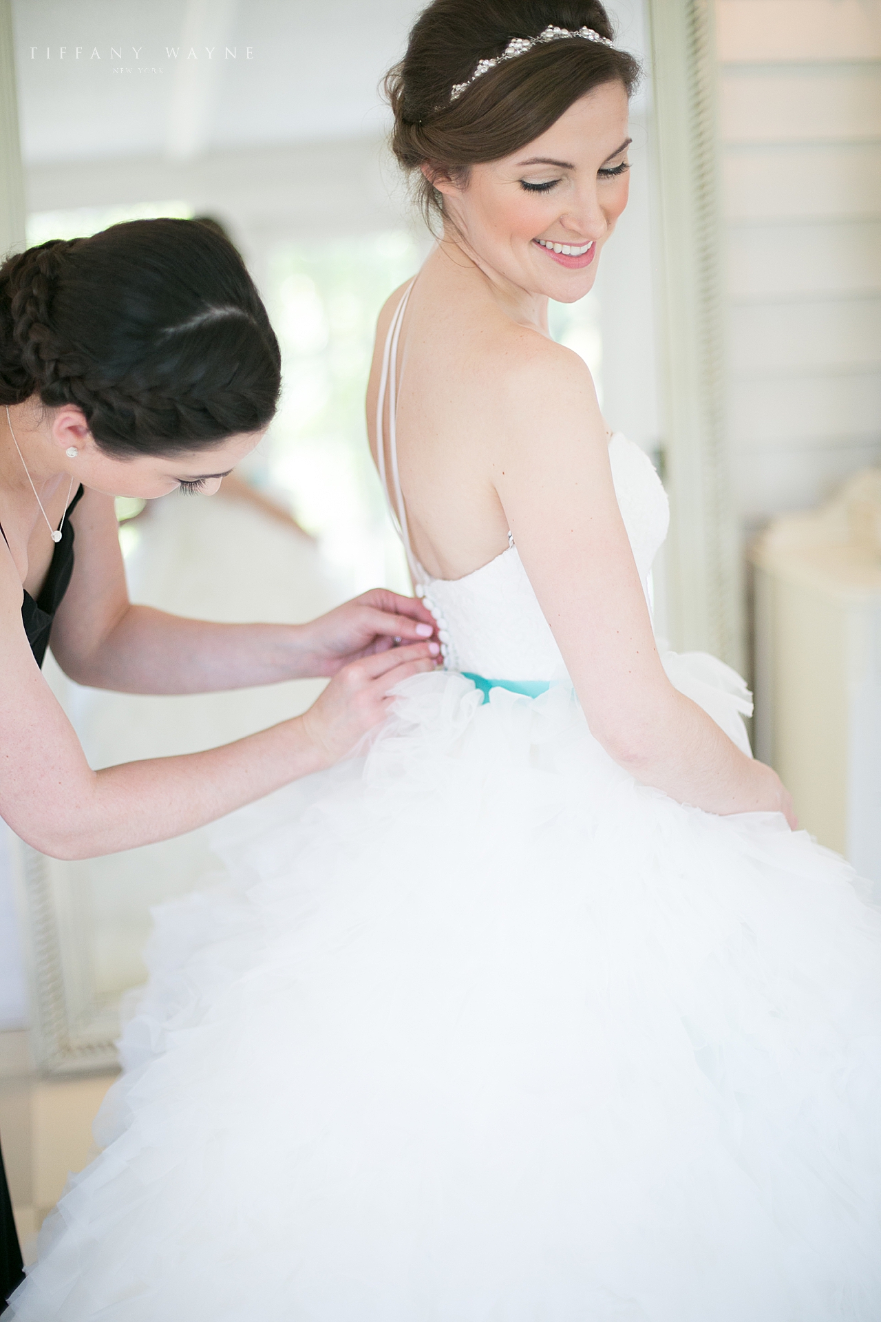 bride gets into wedding gown photographed by destination wedding photographer Tiffany Wayne Photography