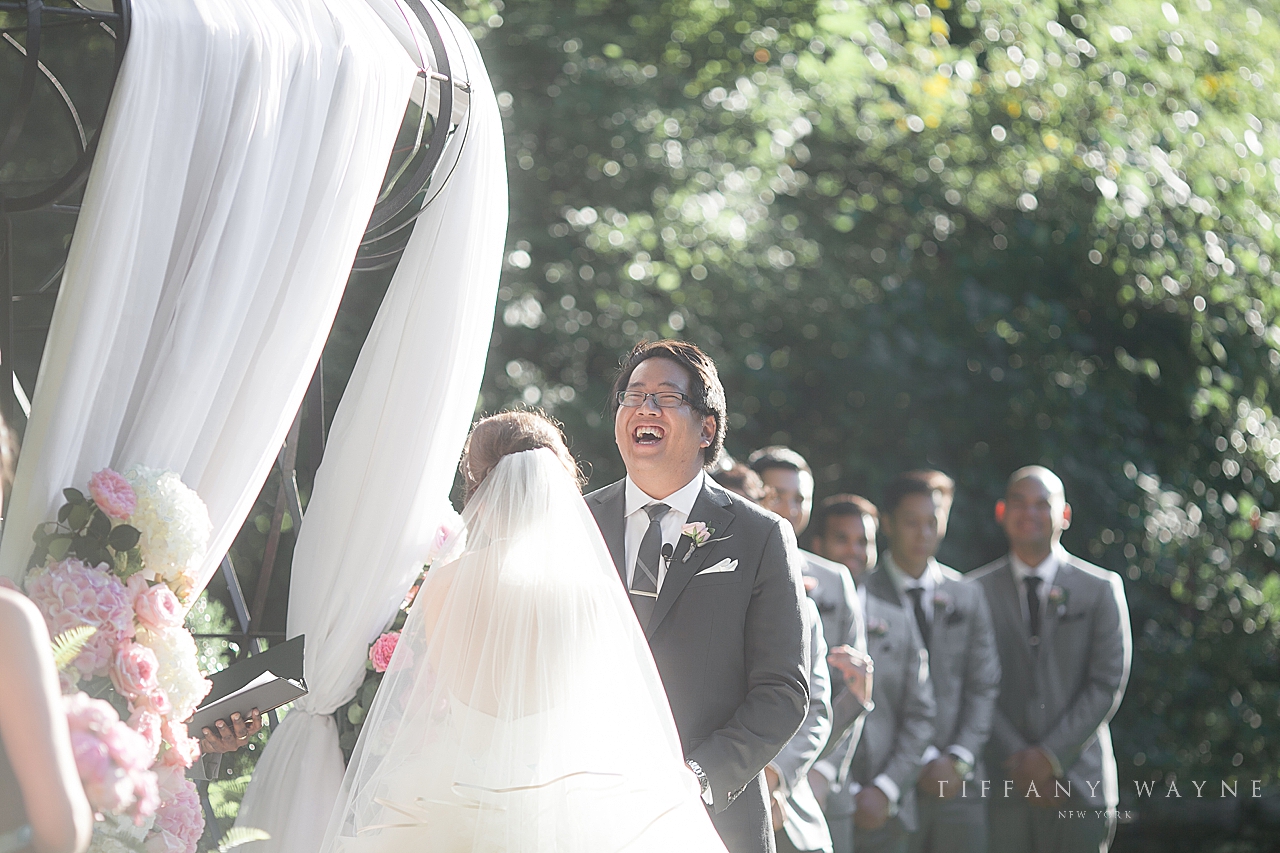 groom laughs during wedding ceremony at Lord Thompson Manor photographed by wedding photographer Tiffany Wayne Photography
