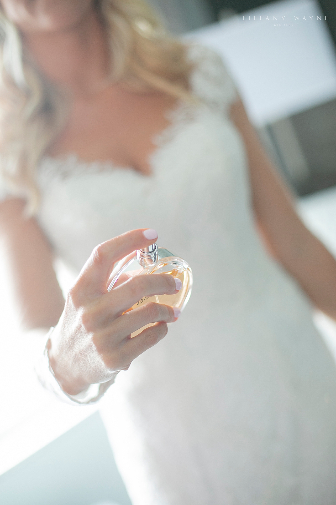 bride puts on perfume photographed by wedding photographer Tiffany Wayne Photography