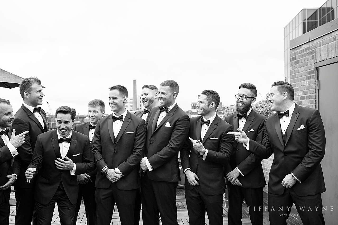 groomsmen watch groom photographed by wedding photographer Tiffany Wayne Photography