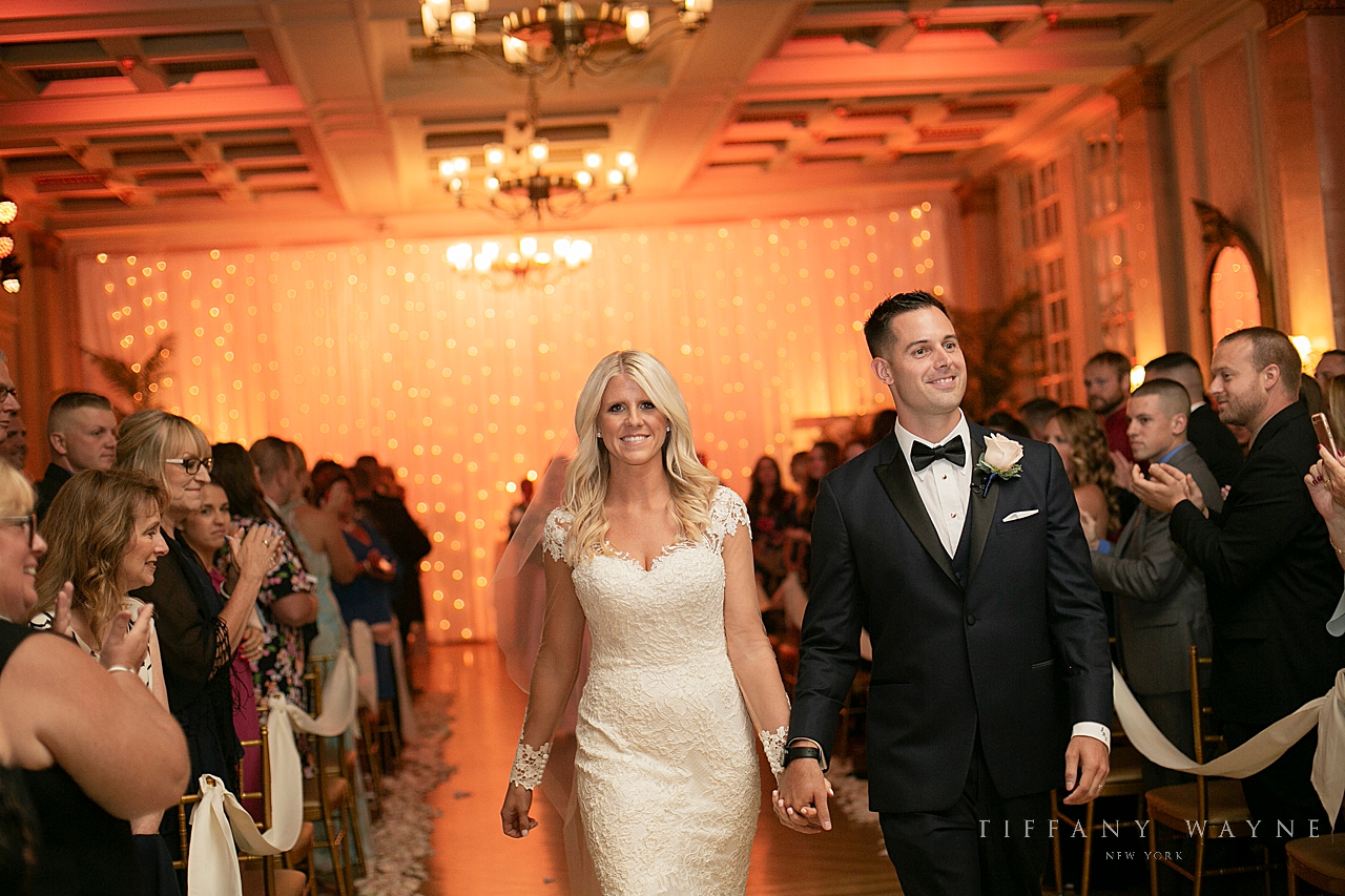 bride and groom recess up aisle photographed by wedding photographer Tiffany Wayne Photography