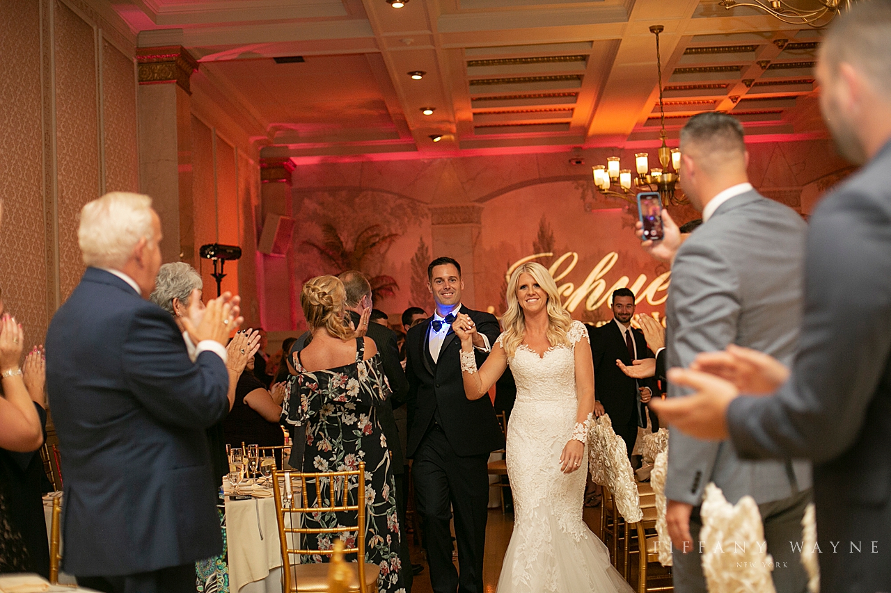 Bride and groom enter reception photographed by wedding photographer Tiffany Wayne Photography