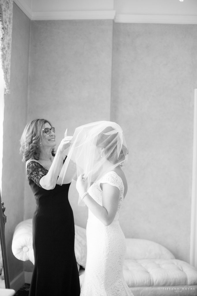 bride adjusts veil for daughter photographed by Tiffany Wayne, New York wedding photographer