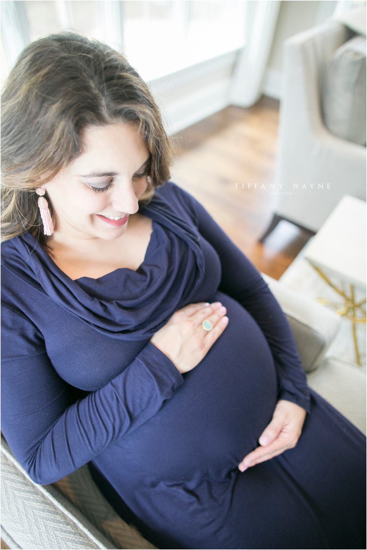Lifestyle maternity session holding baby belly