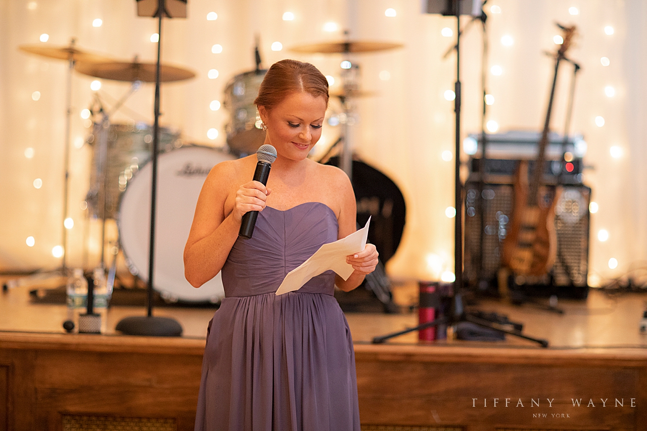 bridesmaid gives toast during reception at Revolution Hall photographed by wedding photographer Tiffany Wayne
