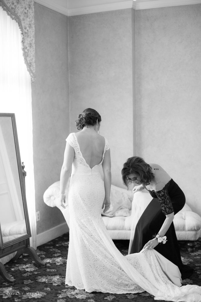 mother prepares daughter for wedding ceremony by Tiffany Wayne, New York wedding photographer