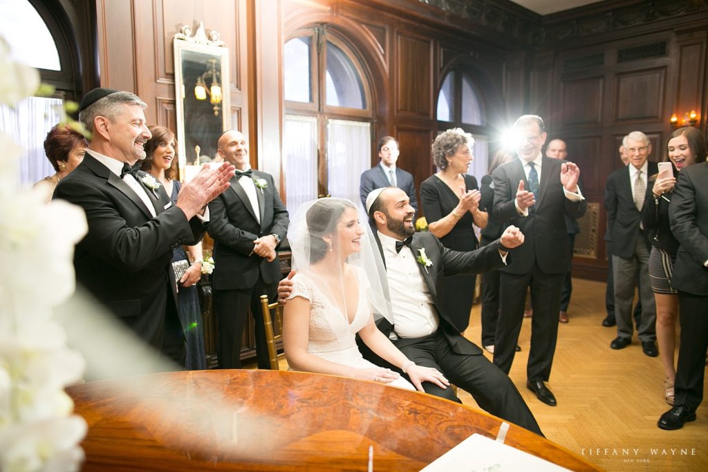 celebrating after signing wedding form photographed by Tiffany Wayne, New York wedding photographer